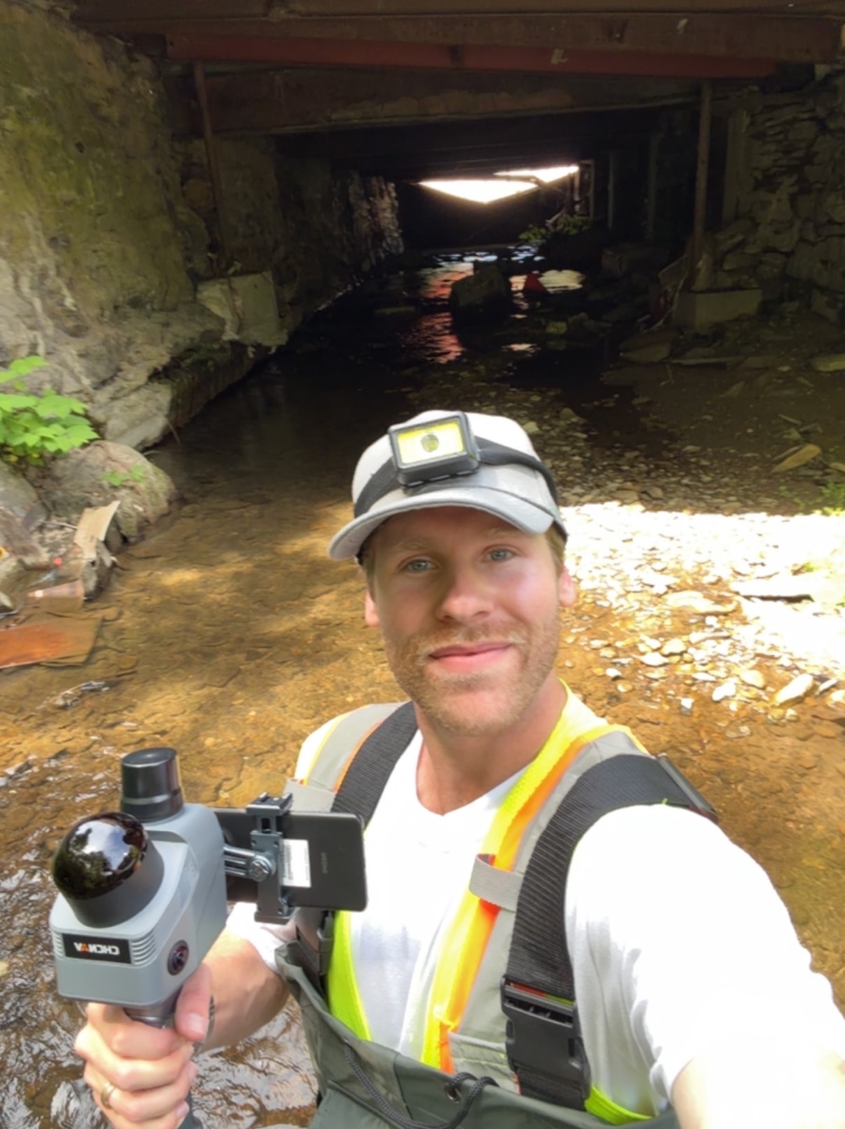 Garrison Wilson performing field data collection at a culvert